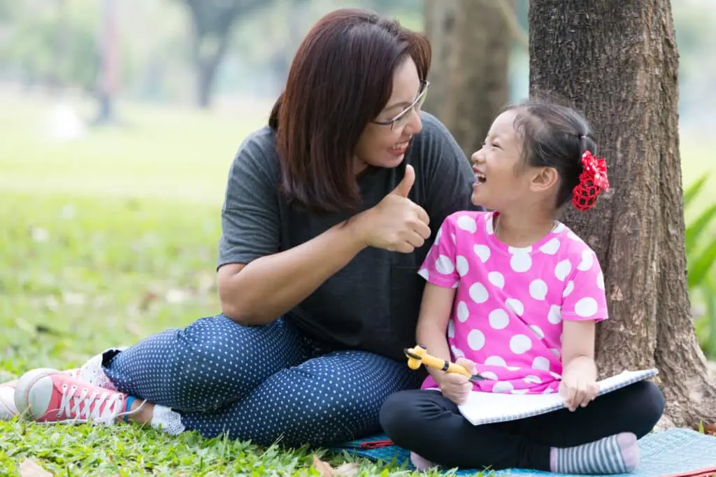 Mother teaching daughter for writing | Sachs Center | Autism ADHD Testing and Treatment Mother teaching daughter for writing